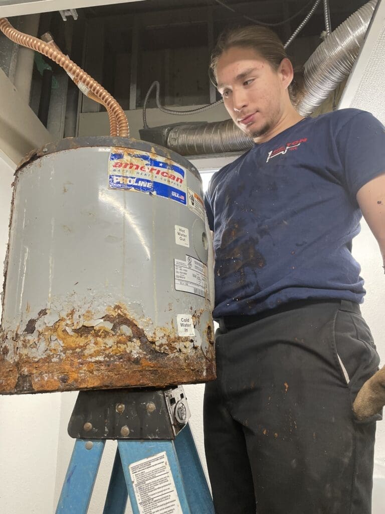 Daniel Garcia (plumber's apprentice) with Heaton Plumbing in Houston Texas Apprentice taking out old water heater